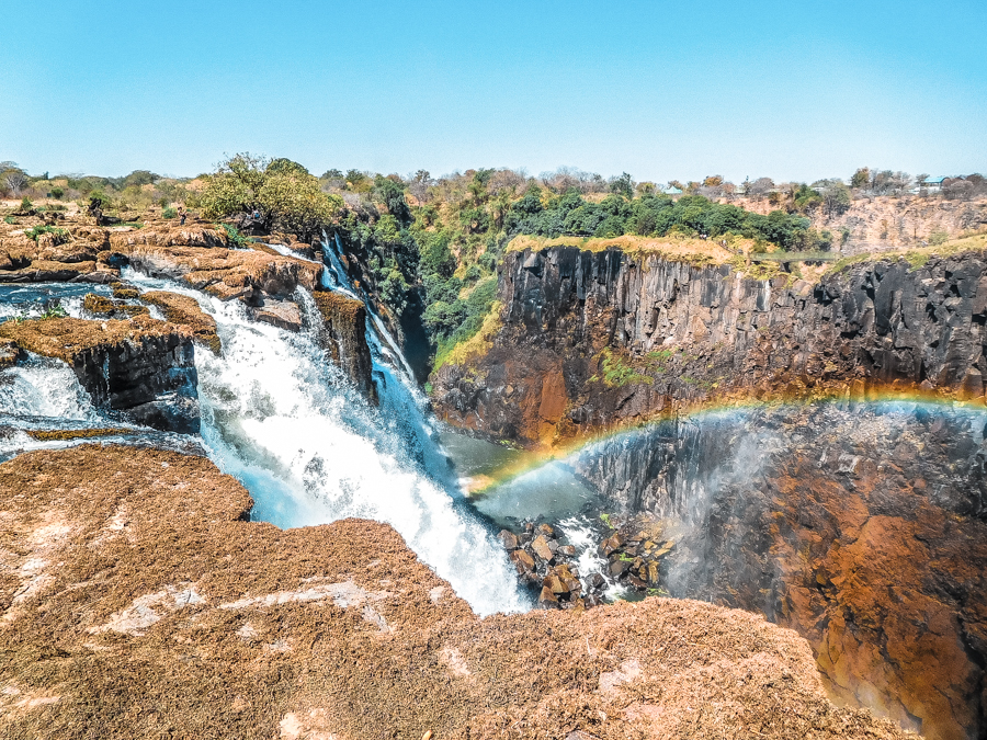 Water crashing down over the Zambezi River from atop Victoria Falls in Zambia. Interested in seeing this in real-life? Check out my guide on how to visit Victoria Falls on a budget